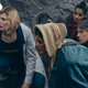 The Doctor, Mary Seacole, Yaz, and Dan look over a rocky outcrop at something unseen.